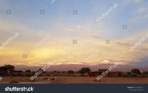 Luci del tramonto nel paesaggio arido e desolato del deserto di Atacama con le cime dei vulcani innevati della cordigliera delle Ande sullo sfondo. Autore e Copyright Marco Ramerini